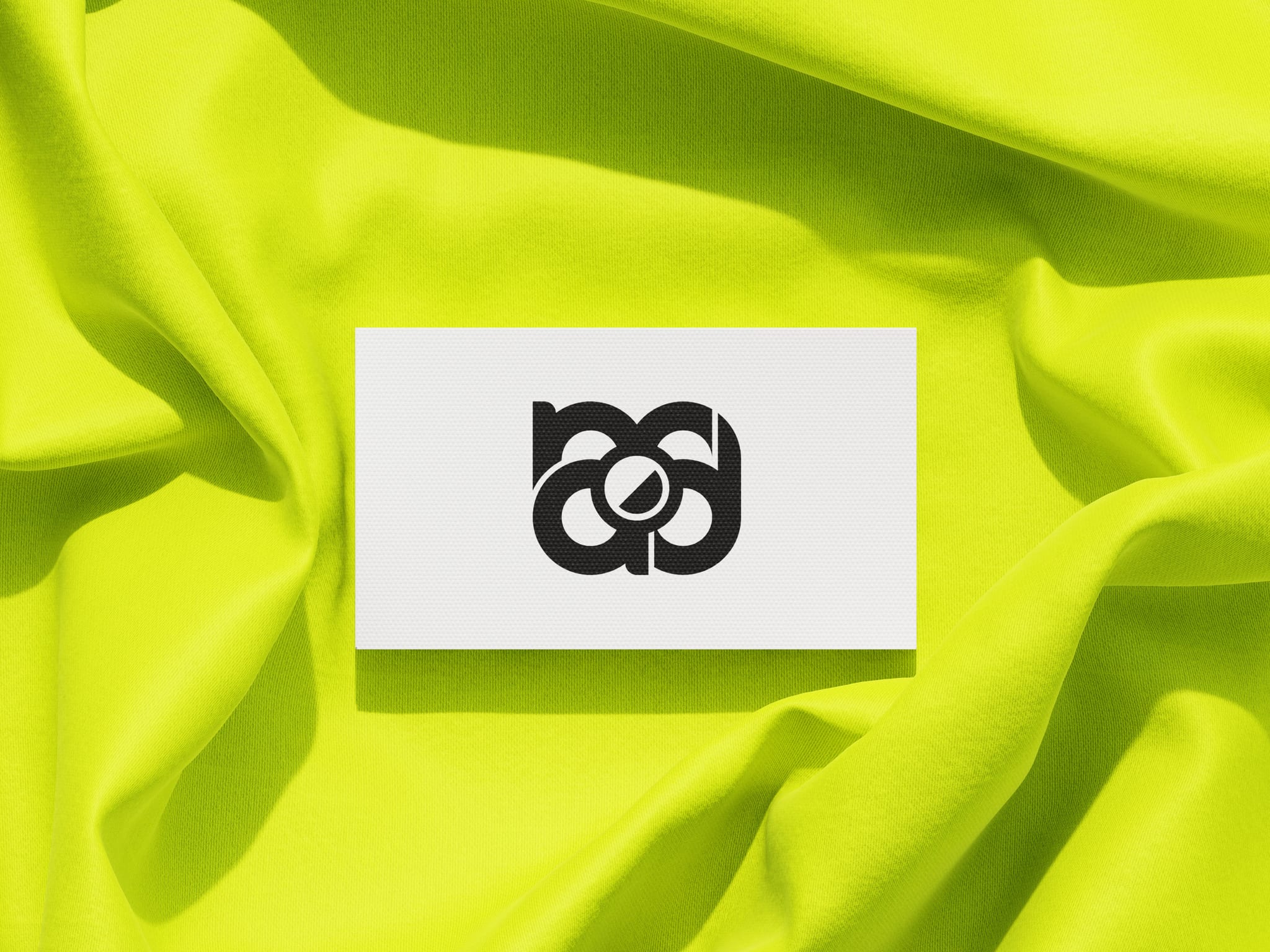 Il biglietto bianco, col monogramma nero, sullo stesso drappo giallo fluo.
